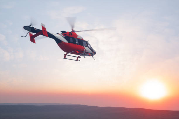 elicottero volante al tramonto - helipad foto e immagini stock