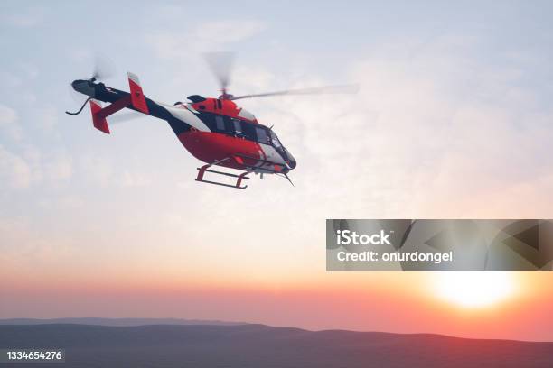 Flying Helicopter At Sunset Stock Photo - Download Image Now - Helicopter, Tourism, Exploration