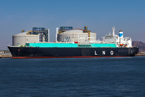 Picture of a large LNG (Liquefied natural gas) tanker ship unloading its cargo at LNG terminal