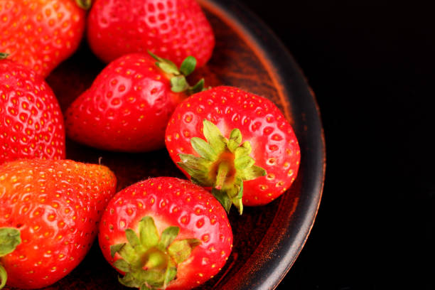 istock Strawberries in a plate on a dark background 1334656733