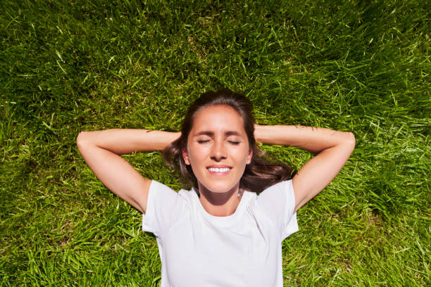 istock Top view of woman lying on the grass 1334657155