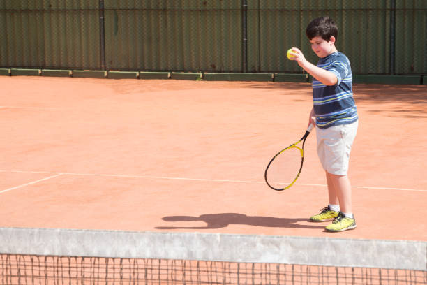 istock child playing tennis 1334657923