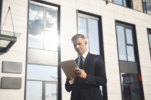 istock Confident mature businessman holding digital tablet 1334658671