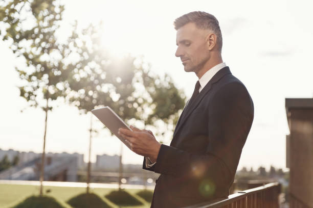 istock Confident mature businessman working on digital tablet 1334658684