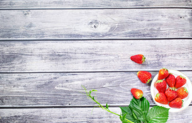 istock Fresh strawberries on wooden texture table, copy space 1334661945