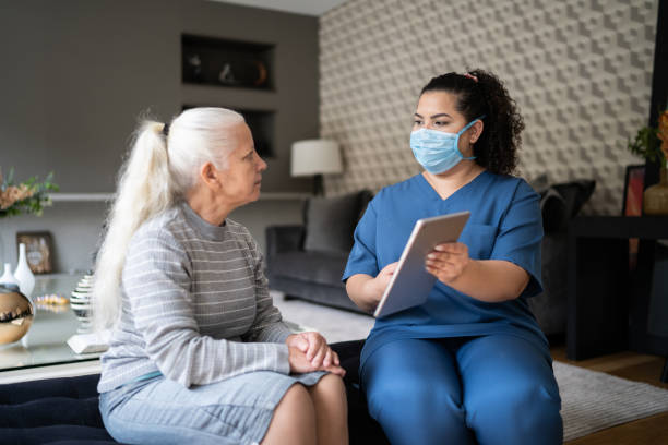 istock Nurse talking to senior patient at home during home visit 1334662927