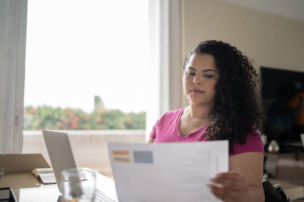 istock Woman using laptop working at home 1334663053