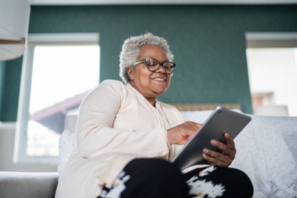 istock Senior woman using digital tablet at home 1334663600