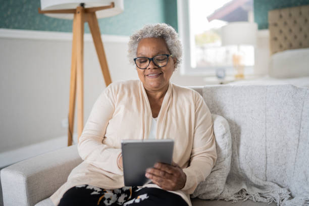 istock Senior woman using digital tablet at home 1334663650