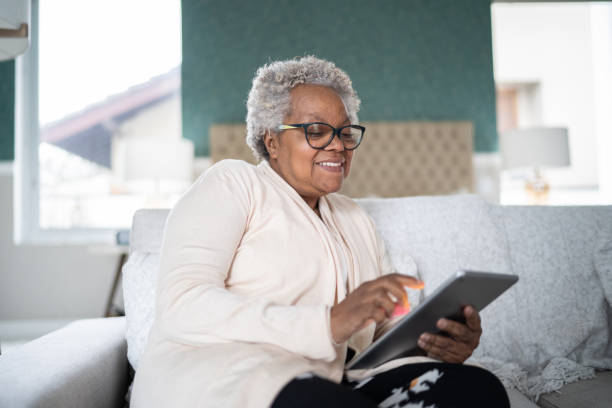 istock Senior woman using digital tablet at home 1334663784