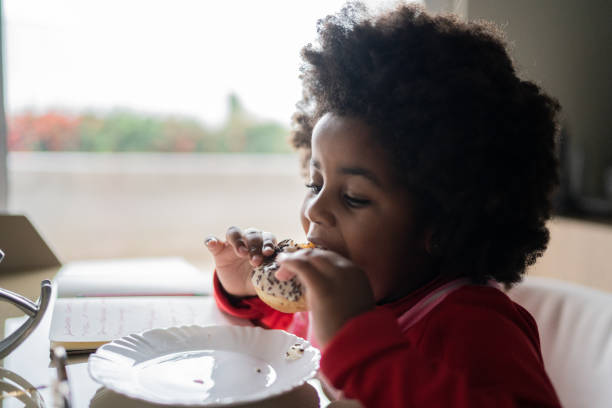 istock Girl eating sandwich at home 1334663812