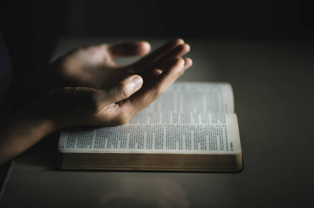 le donne pregano dalla benedizione di dio per avere una vita migliore. le donne consegnano pregando dio con la bibbia. credere - please god foto e immagini stock