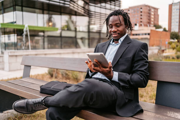 istock Businessman Working on his tablet on bench 1334665003