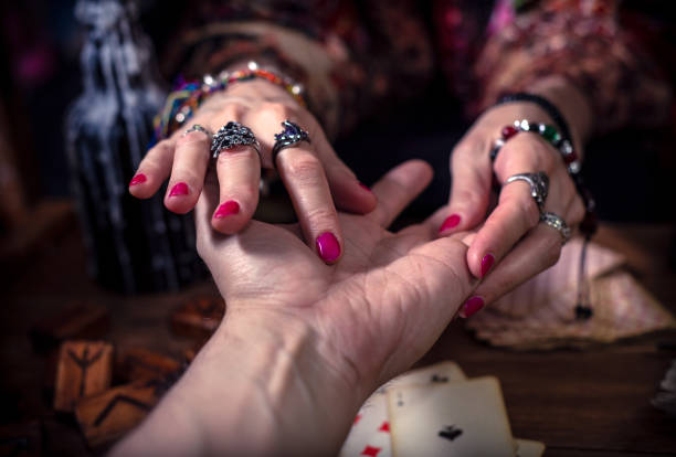 istock Gypsy fortune teller predicts the future by chiromancy 1334665075