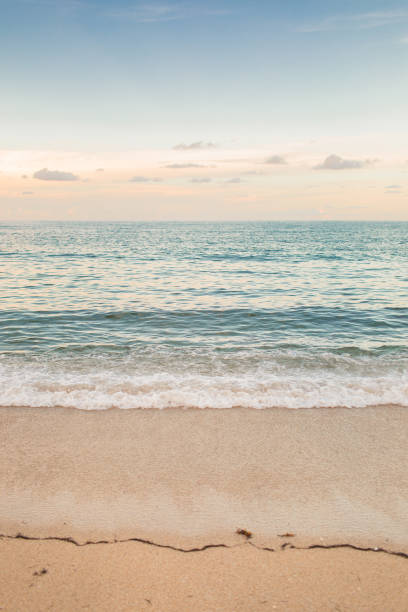 istock Teal Ocean Waves Sweeping Along the Empty Beach Shoreline at Sunset in Highland Beach, Florida in August of 2021 During the Rise of the COVID-19 Delta Variant 1334665327