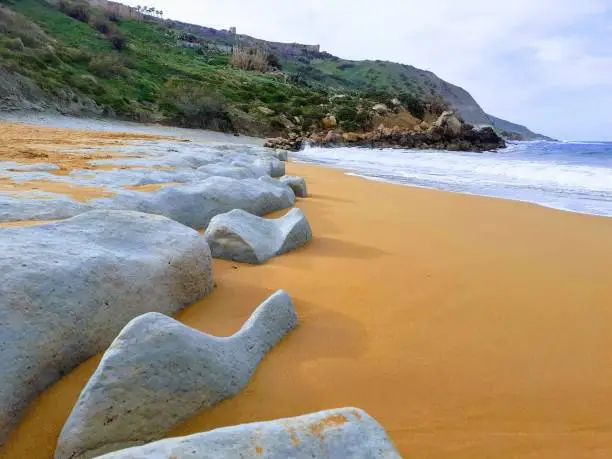 Rocks by the Mediterranean Sea on red sand beach