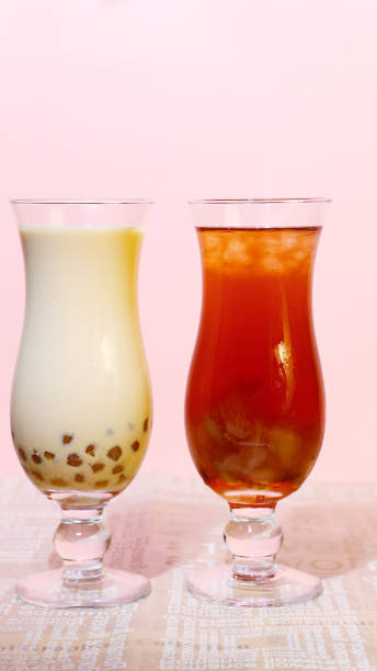 Close-up of two summer drinks on pink background, cool and refreshing