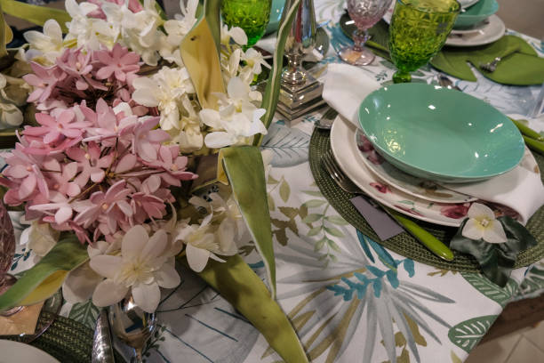 istock still life table setting. Vase with flowers, candles, blue tablecloth, beautiful plates. Table decor 1334672396