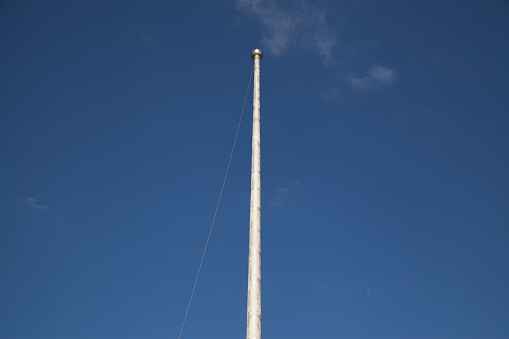 Lightning rod on pole, blue sky background