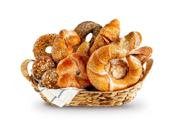 istock Various kinds of breadstuff (bread rolls) in the rustic basket isolated on white 1334673836