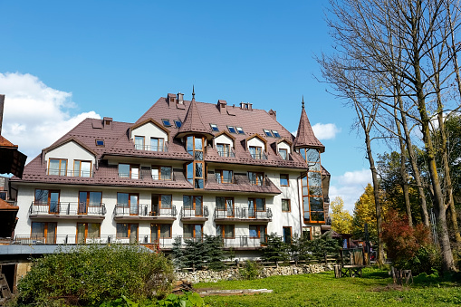 Zakopane, Poland - October 14, 2014: Litwor Hotel, five-star hotel built in 1999, offers 51 luxurious rooms, located just off the Krupowki street, the main shopping and pedestrian promenade in the city. The city of Zakopane is located at the foot of the Tatra Mountains in southern Poland. The unquestionable attraction of the city is the diversity of traditional wooden architecture, which has its own style characteristic for this region. Modern architecture in this city very often also refers to the architectural traditions of this local style. Due to its location, the area is visited by many tourists at any time of the year in order to enjoy the marvelous nature and mountain landscapes or to take advantage of sports opportunities. The city is one of the most visited cities in Poland, both by domestic and foreign guests. Due to the variety of winter sports opportunities, this city is commonly called the winter capital of Poland.