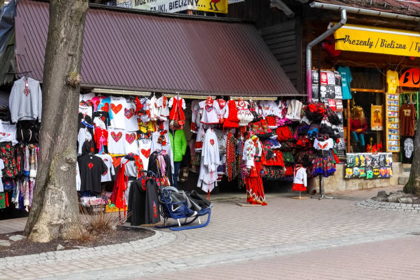Zakopane, Poland - March 09, 2016: Various clothes decorated with regional designs offered for sale from the stand located along the famous Krupowki street. Zakopane, due to its attractive location in the immediate vicinity of the Tatra Mountains is a city that is often and willingly visited by tourists.