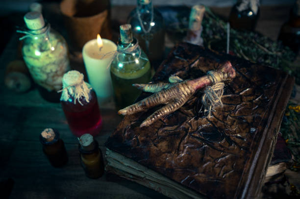 istock A witchery stuff: multiple tincture bottles, bunches of dry healthy herbs, stack of ancient ritual books, amulets, candles, runes chicken feet, sack of medicinal and magical herbs 1334678918