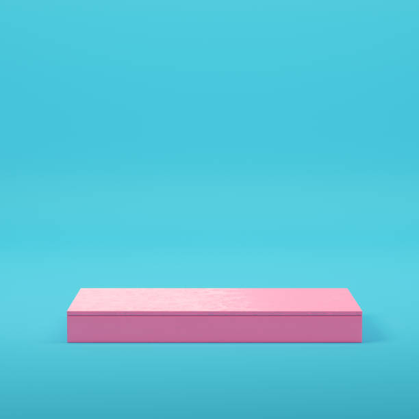 istock Pink rectangle podium for product display on bright blue background in pastel colors 1334683019