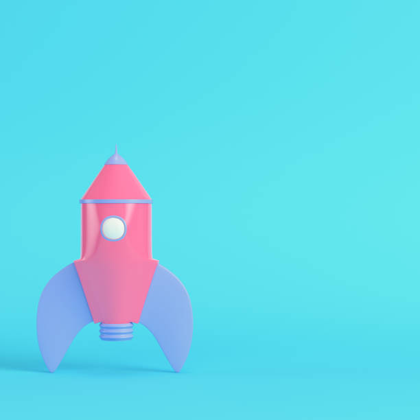 istock Pink cartoon styled rocket on bright blue background in pastel colors 1334683184