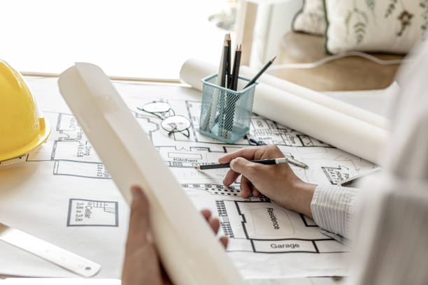 istock The architect wrote on the blueprints to modify the design after discussing with the client, designing the house according to the owner's requirements and in accordance with the construction standards 1334684349