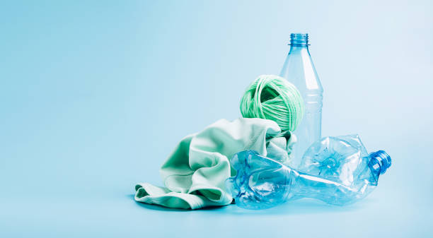 istock Empty plastic bottle and various fabrics made of recycled polyester fiber synthetic fabric on a blue background 1334685033