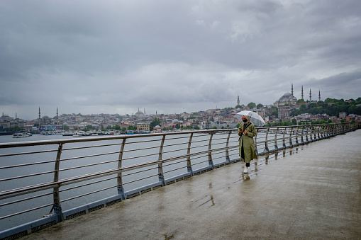 Walking on the Istanbul's bridge at a rainy day