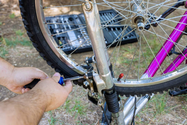 istock Mechanic repairman installing assembling or adjusting bicycle gear on wheel 1334689334