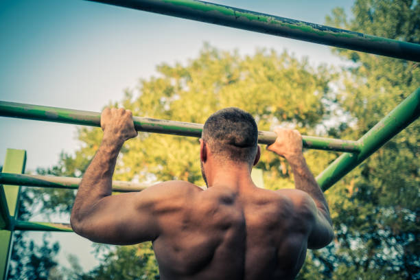 istock back view of muscular sportsman doing pull ups 1334689872