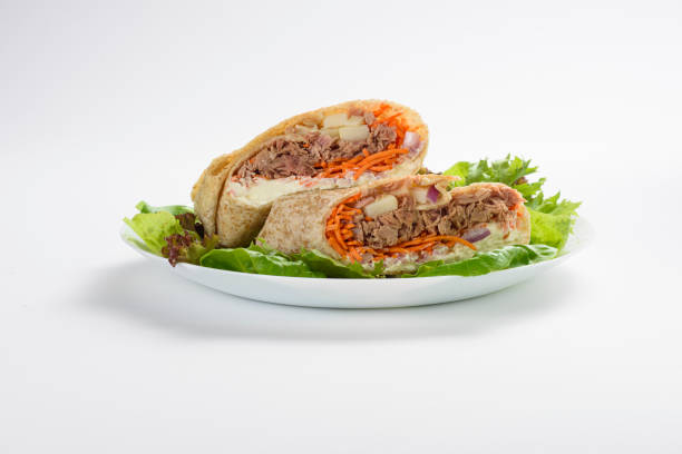 вид спереди на вкусную обертку с тунцом, морковью и сыром, изолированный - sandwich healthy eating wrap sandwich food стоковые фото и изображения