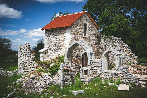 Old stone chapel in the village of Saint Alban, ancient ruined church. Photo taken near Cerdon village in Bugey mountains, in Ain departement, Auvergne-Rhone-Alpes region in France, in Europe, shot during a sunny summer day.