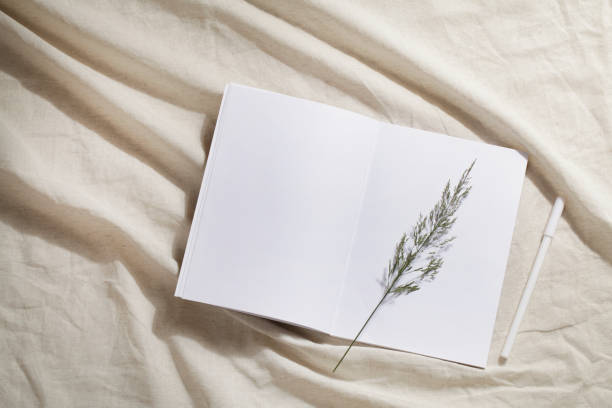 istock workplace with notebook, pen, grass on linen textile. Kinfolk designed interior. minimal, stylish concept. new trendy home decor. 1334691960