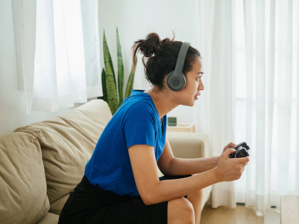 istock Asian E-sport Player Playing Video Games With Her Headset. 1334694491