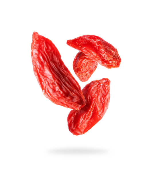 Dried goji berries close up in the air on a white background