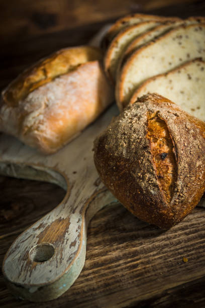 istock Assorted homemade healthy bread on rustic wooden background 1334694821
