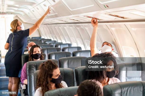Passengers Flying Stock Photo - Download Image Now - Airplane, Protective Face Mask, Cabin Crew