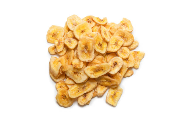istock Banana chips isolated on a white background. Dehydrated banana. 1334697305
