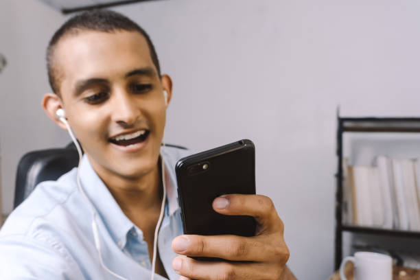 istock portrait of a young latinx using a mobile smart phone. technology concept. 1334699772