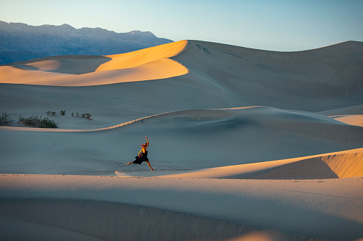 Man Walking through the Desert Dunes, Mexicali, Baja California,Sonoran Desert.