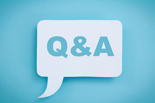 Q and A written on a white speech bubble, on a blue background.
Q&A  concept.