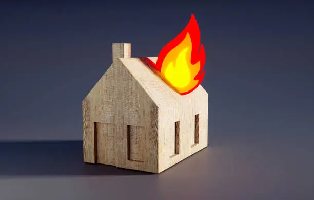 Photo of Toy house with bright fire symbol