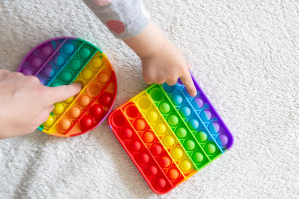 istock Modern trendy toy Pop it for children with flexible silicone material 1334714499
