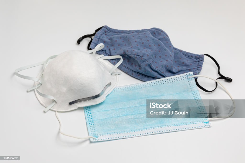 N95, surgical and cloth face masks. Covid-19 face mask choices, comparison and protection concept isolated, white background Protective Face Mask Stock Photo