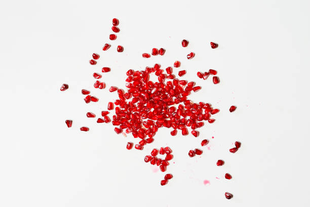 istock Ripe pomegranate seeds on white 1334717656