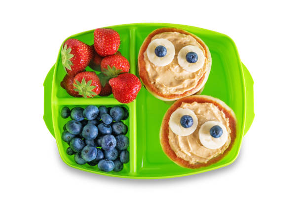 istock Kid's healthy breakfasts with funny faces in a container on a white isolated background 1334717771